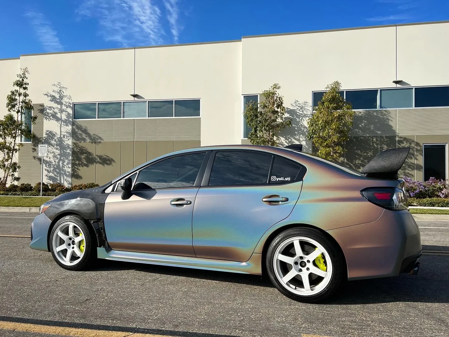 Color-shifting sedan outside The Wrap Source