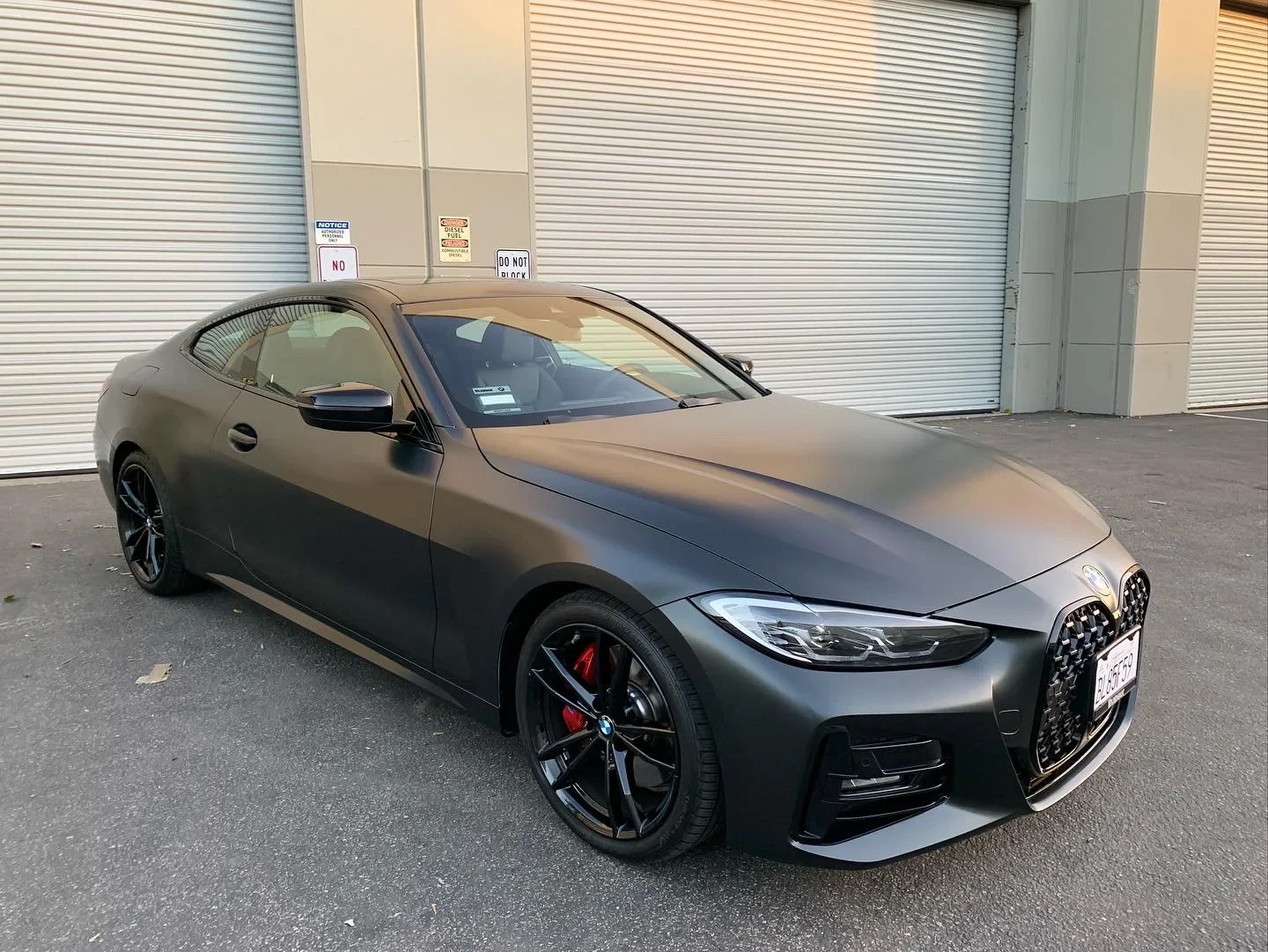 Satin-gray BMW outside the shop
