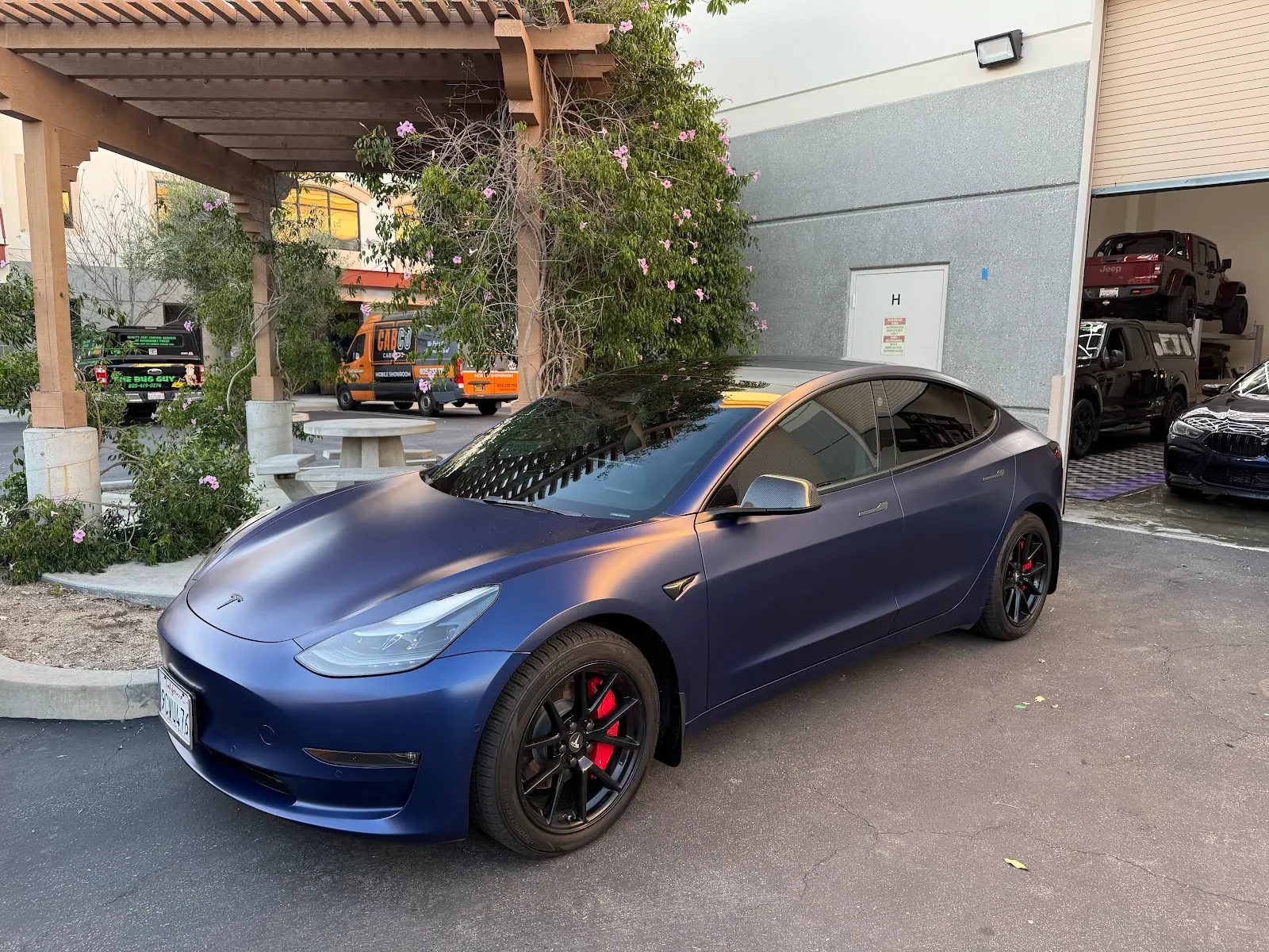 Blue Tesla Model 3 outside The Wrap Source